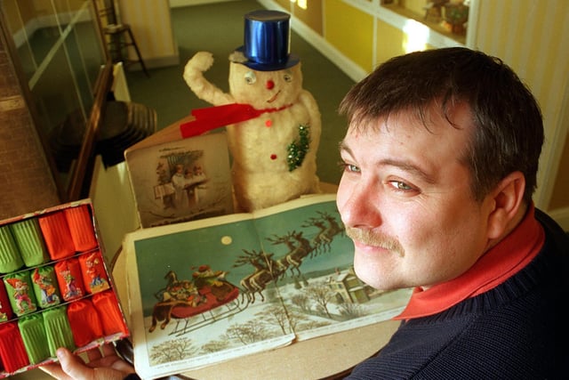 Mark Kilvington, a visitor assistant at the Abbey House Museum in Leeds, with a selection of Christmas goodies from over the last fifty years.