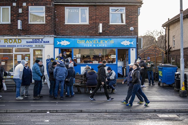 Leeds United fans queue at Graveley's fish and chips shop ahead of kick-off.