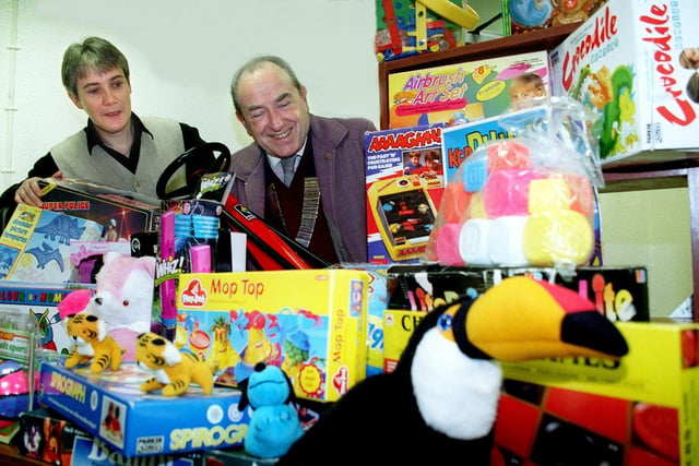 Blackpool Lions Club donated several sacks full of toys to the Fylde Coast Women's Refuge for Christmas, 1997
Pic shows Refuge Project Co-ordinator Chris Hill (left) admiring the mountain of toys with Lions' President Ken Ogden.