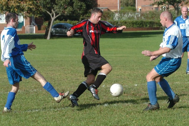 Stanley Arms v AFC Lupset, Division 2 Wakefield and District League, Andrew Smith of Stanley Arms, goes between Kevin Baddan and John Mattinson of AFC Lupset