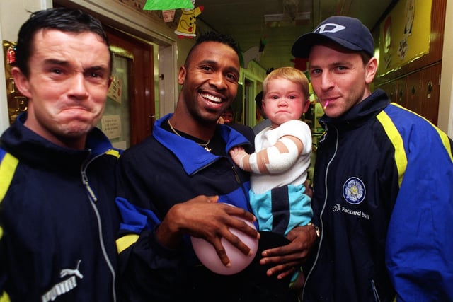 Leeds United's Gary Kelly pulls the same face as 17 month old Jamie Underdownwhile Lucas Radebe and Lee Sharpe try to get a smile out of him during a visit by the team to the children's wards at St James's Hospital.