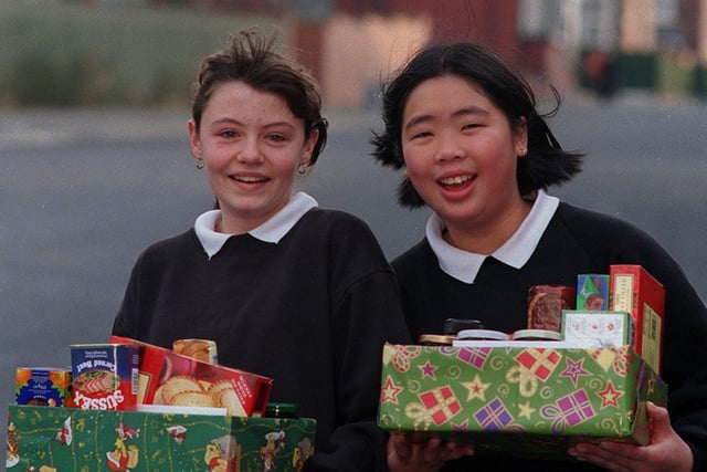 Matthew Murray High School pupils Louise Vause (left) and Emmie Wai leaving the school with Christmas food parcels for pensioners in the Holbeck area.