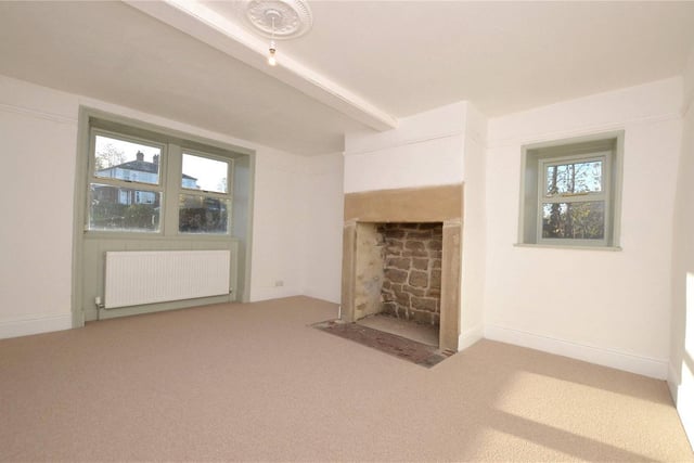 Another reception room on the ground floor features a beautiful period fireplace, and could be used as another living room, a snug or a dining room.
