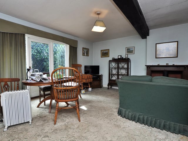 A beamed room with open plan aspect, and the large windows.