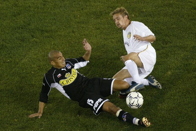 Stephen McPhail collides with Colo Colo's Joel Reyes during a friendly played at Melbourne's Colonial Stadium in July 2002.
