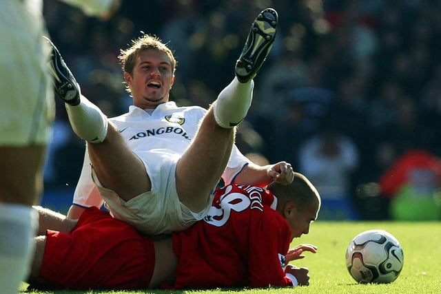 Stephen McPhail lands on top of Liverpool's Bruno Cheyrou after a tackle during the Premier League clash at Elland Road in October 2002.