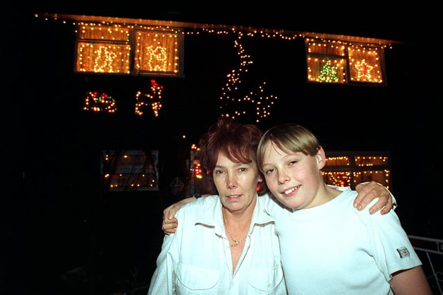 This is Elaine Idle with her son Jay outside their home in New Farnley in December 1997. She spent more than two weeks putting up over 2,500 Christmas lights inside and outside her home.