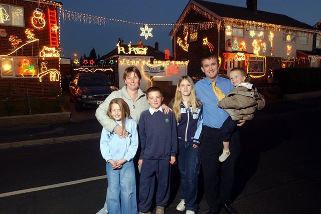 Families on Windermere Drive in Garforth decorated their homes with Christmas lights for charity in December 2003. Pictured is June Rollins (left) with children Jade and Thomas. Also pictured is Nigel Burton-Power with children, Joshua and Charlotte.