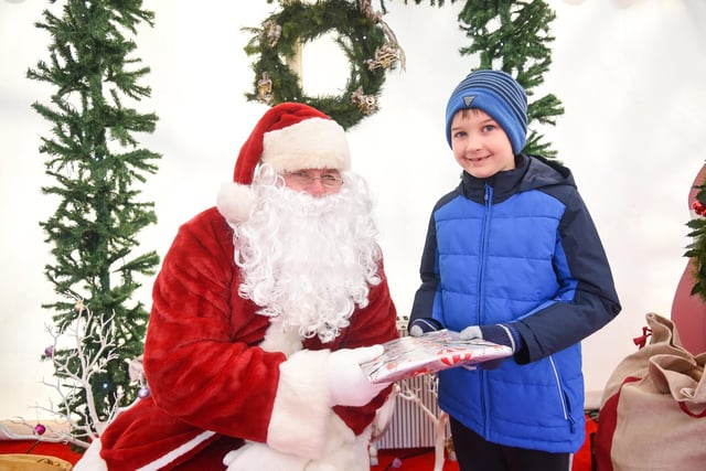 Eight year old Oliver Weaver meets Santa.