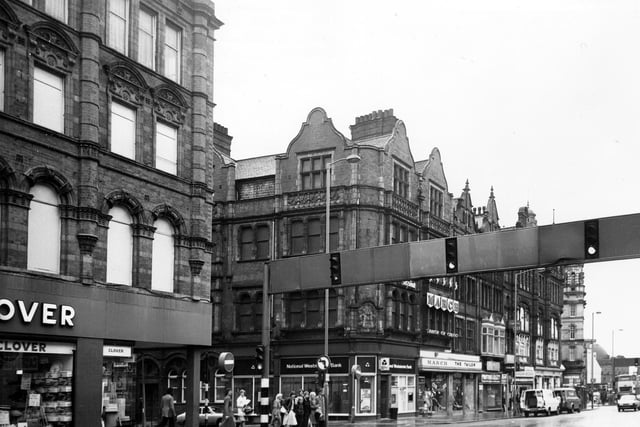 Vicar Lane to the junction with Sidney Street in December 1979.  Pictured from left is Clover department store, National Westminster Bank, March the Tailor, Photomarket and Bargain Records.