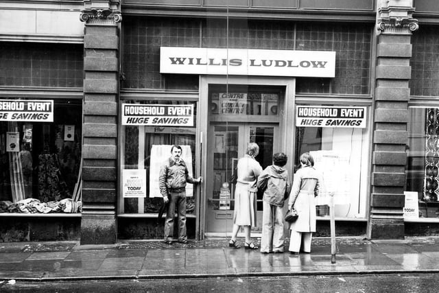 The Willis Ludlow department store on the Ludgate Hill side of Kirkgate Market pictured in January 1979. Shoppers are looking in the windows which advertise 'Huge Savings'.