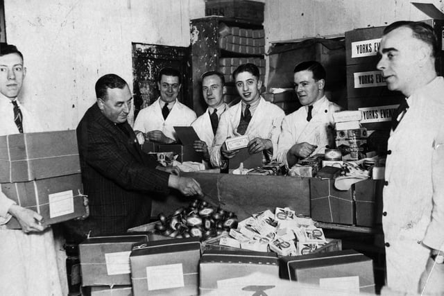 Food parcels being prepared to provide Christmas cheer to those poor homes in December 1934.