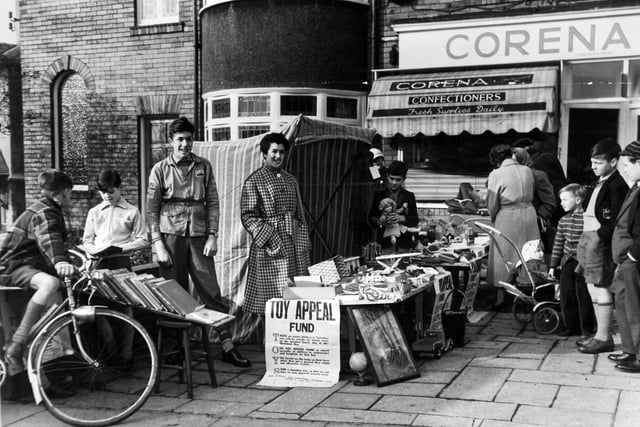 The Redhaw family set up a stall outside Moortown Post Office in November 1958 selling books, sweets and fancy goods. Standing by the stall are, from left, Martin Redshaw, 15, Mrs. R. B. Redshaw and Digby, ten.