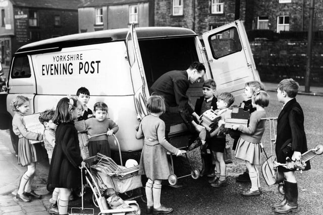 Children of Lower Wortley Infants School are seen handing toys they had collected to an Evening Post van driver in November 1954.