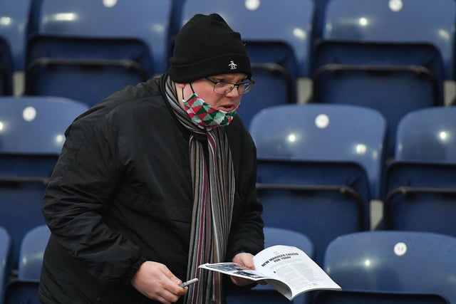 A PNE fan has his copy of the official match day programme