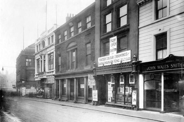 Commercial Street in December 1922. This photo shows the premises of John Wales Smith and Sons Ltd., a tailor, then Alexander Hasse, fine art dealer. Also visible is Madame Darling, Ltd. ladies costumier. This is housed in Trinity House on the corner of Trinity Street.