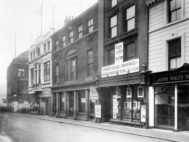 Commercial Street in December 1922. This photo shows the premises of John Wales Smith and Sons Ltd., a tailor, then Alexander Hasse, fine art dealer. Also visible is Madame Darling, Ltd. ladies costumier. This is housed in Trinity House on the corner of Trinity Street.