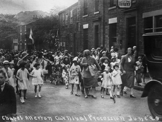 June 1920 and pictured is a section of Chapel Allerton Carnival procession passing the Regent Inn on Regent Street. This part of the parade has children in fancy dress, shepherded along by ladies dressed in the fashion of the period.