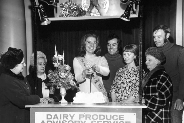 Leeds, 14th December 1970  At the Women's Circle meeting at the Hotel Metropole, Leeds, are (from the left);  Mrs. Gertrude Hart, of Beeston, Leeds; Mrs. Alice Atkin, of Cross Gates; Miss Julie Greenleaf, the National Dairy Queen, 1970, cutting the Women's Circle Christmas cake; Mr. Edward Elfes, of Eric Nunns, florists, of Harrogate; Mrs. Rosemary Sloan, Dairy Produce Adviser, Milk Marketing Board; Miss Laura Crowther, of Beeston and Mr. Eric Nunns.
