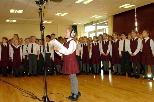Ellie Kempley, seven, a pupil at Ashville College Junior School, reaching on tiptoes for the microphone as the Junior School record a Christmas CD.