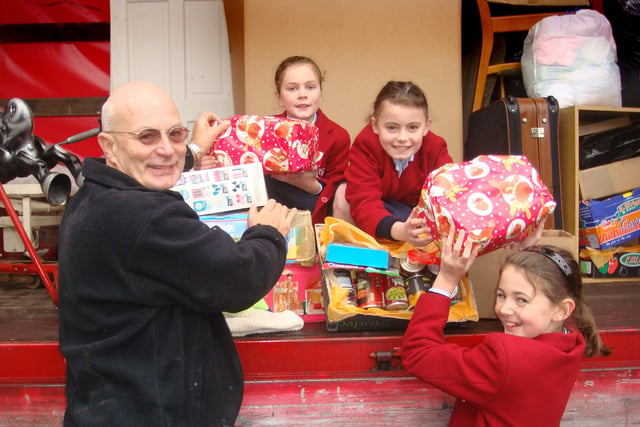 Pupils at an independent prep school on the outskirts of Harrogate are helping children at a Hungarian orphanage to have a happy Christmas. Youngsters at Belmont Grosvenor School, based at Swarcliffe Hall, Birstwith, have donated tins, jars and packets of food from their annual Harvest Festival to the Gyor orphanage in Hungary. Picture shows Harrogate charity worker Tony Frazer with children from left, Alicia Kernaghan, 8, Sophie Belcher, 8 and Emily Kernaghan, 10.