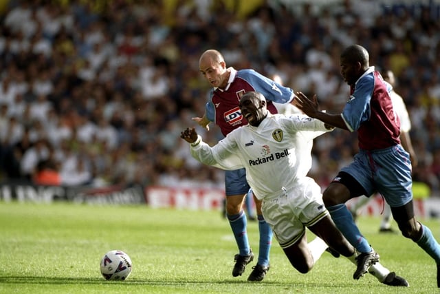 Jimmy Floyd-Hasselbaink is brought down by Aston Villa's Ian Taylor (right) as Alan Wright watches on during the Premiership clash at Elland Road in September 1998. The game finished goalless.