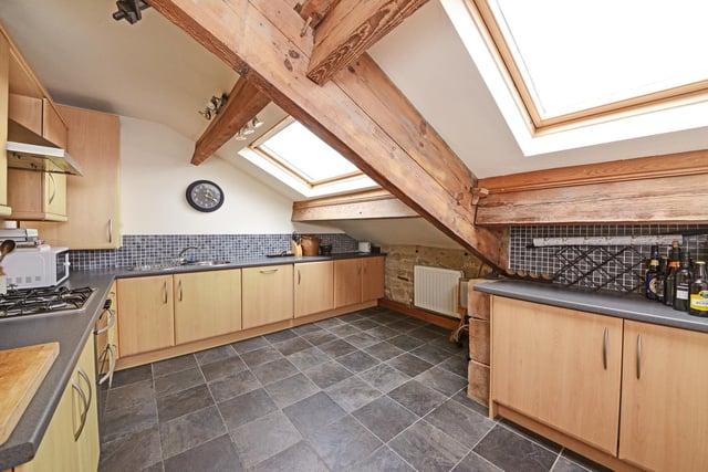 The kitchen includes integral appliances and has ample storage with its fitted units.