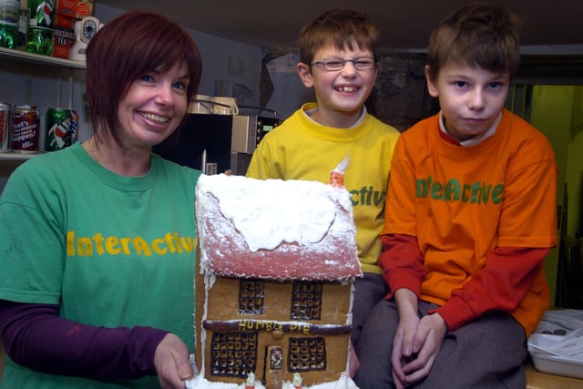 Sue Boyes, of Interactive, raffles a gingerbread house to raise money.