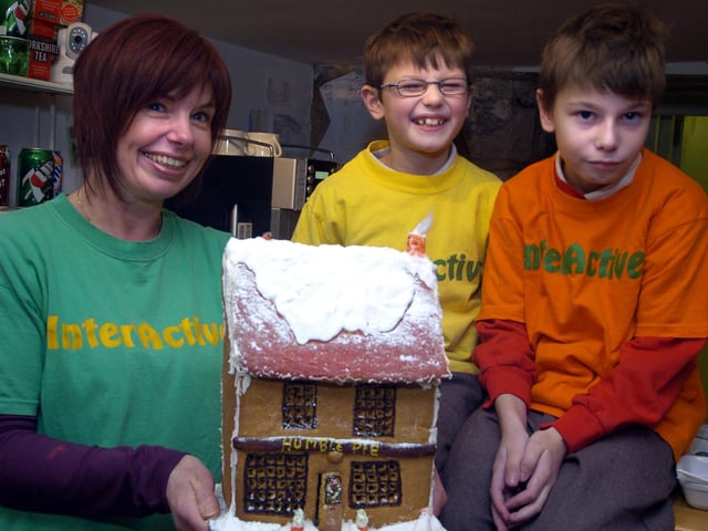 Sue Boyes, of Interactive, raffles a gingerbread house to raise money.
