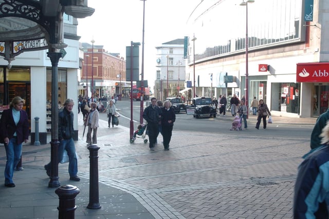 A view of Church Street looking towards the promenade and  Market Street from Grand Theatre door 2007. British Home Stores is on the right and the Abbey (bank) on the corner of Corporation Street. On the left is Clarks shoe shop.