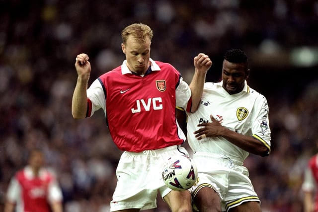 Arsenal's Dennis Bergkamp controls the ball under pressure from Lucas Radebe.