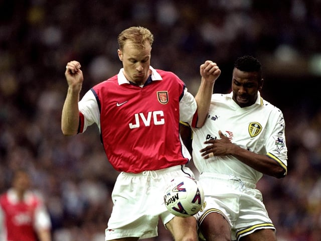 Arsenal's Dennis Bergkamp controls the ball under pressure from Lucas Radebe.