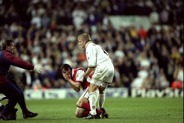 Nigel Winterburn of Arsenal is injured during the clash.