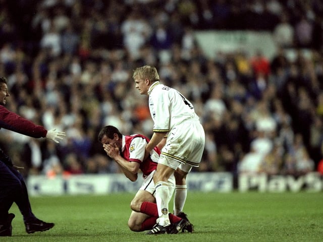 Nigel Winterburn of Arsenal is injured during the clash.