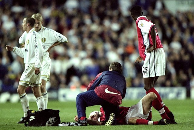 Arsenal's Nigel Winterburn receives treatment from physio Gary Lewin after being kicked in the face by Alf Inge Haaland.