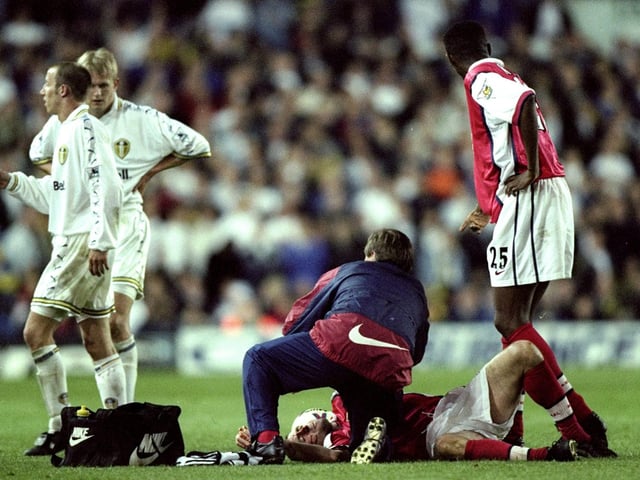 Arsenal's Nigel Winterburn receives treatment from physio Gary Lewin after being kicked in the face by Alf Inge Haaland.