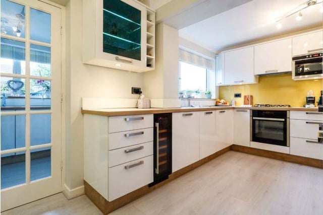 The open plan kitchen/diner is a modern space with fitted appliances and a separate utility area.