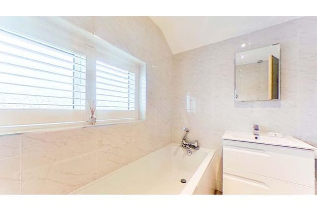The family bathroom is a good size with a bathtub and separate shower.