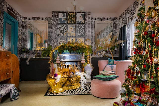 The tree in the sitting room has a cosmetics theme with lipstick and nail varnish decorations from Home Bargains and a Chanel inspired decoration from Etsy. The fireplace features an OTT garland and the glass-topped table is home to a herd of reindeer