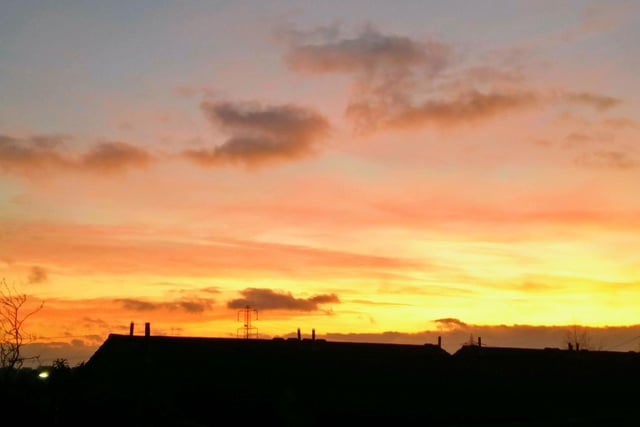 A stunning sunset over the rooftops, by Jean Reeve