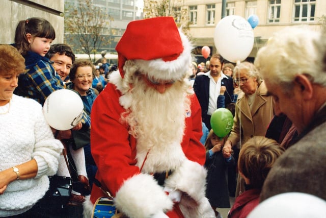 Santa entertains the younger members of the crowd. A number of balloons are printed with '1932 -50 years-1982 Golden Anniversary'.