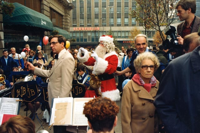 Santa helps to conduct the jazz band playing in Dortmund Square.
