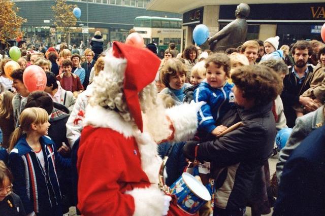 Santa greets a young fan.