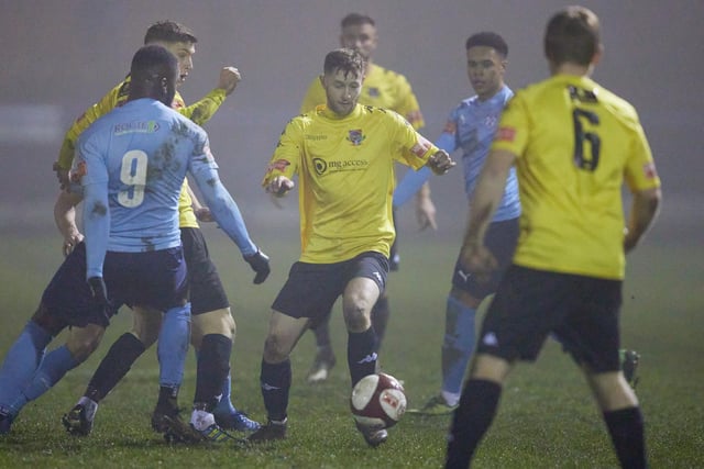 Gavin Rothery on the ball as he comes up against Ossett United's Roy Fogarty in Pontefract Collieries' win.