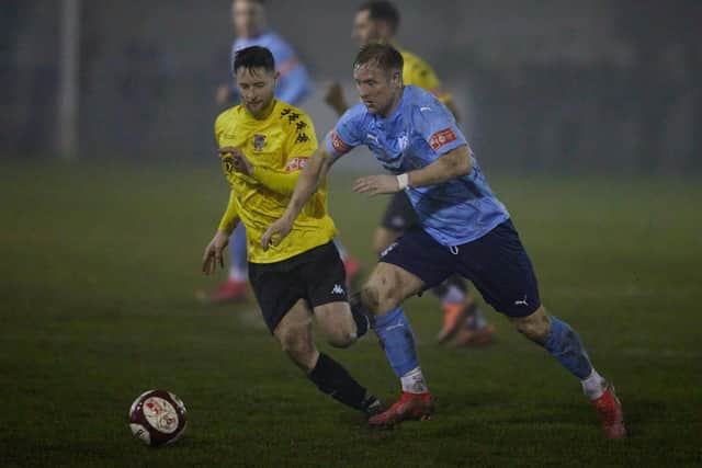 Ossett United's James Walshaw comes up against Pontefract Collieries goal scorer Gavin Rothery. Picture: John Clifton