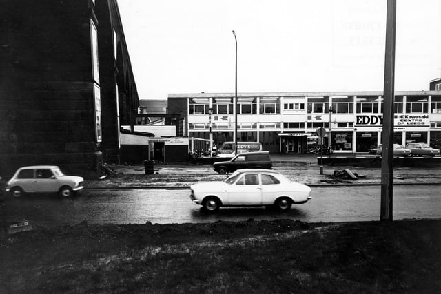 Kirkstall Road in December 1980. Pictured is Eddy's Motorcycle Showroom, which describes itself as the 'Kawasaki Centre of Leeds'. The arches of the railway viaduct can be seen on the left.
