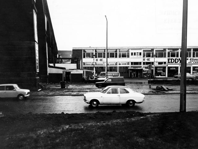 Kirkstall Road in December 1980. Pictured is Eddy's Motorcycle Showroom, which describes itself as the 'Kawasaki Centre of Leeds'. The arches of the railway viaduct can be seen on the left.