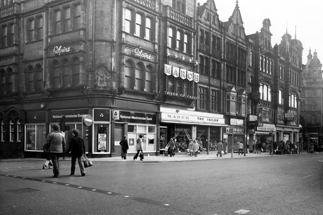 Vicar Lane showing the junction with Sidney Street on the left in January 1980. Shops include National Westminster Bank, March the Tailor, Photomarket and Bargin Records. The junction with Ludgate Hill and Kirkgate Market Buildings can be seen on the far right.