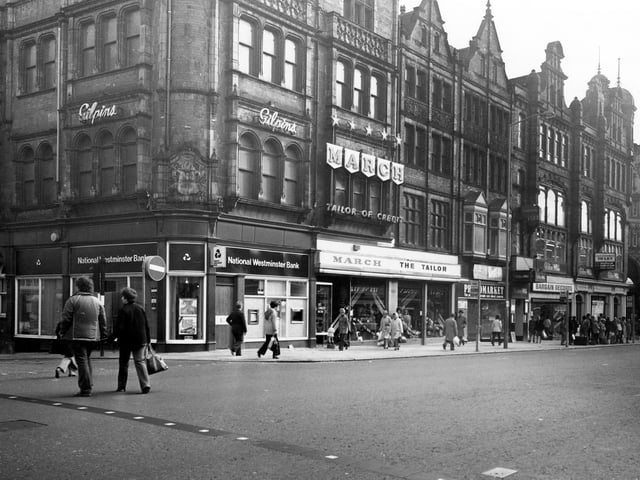 Vicar Lane showing the junction with Sidney Street on the left in January 1980. Shops include National Westminster Bank, March the Tailor, Photomarket and Bargin Records. The junction with Ludgate Hill and Kirkgate Market Buildings can be seen on the far right.