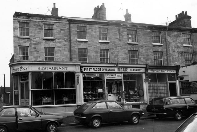 Shops on Boston Spa High Street in March 1980 featuring The Spice Box restaurant, Boston Office Supplies and Mayfair Hair Styles.